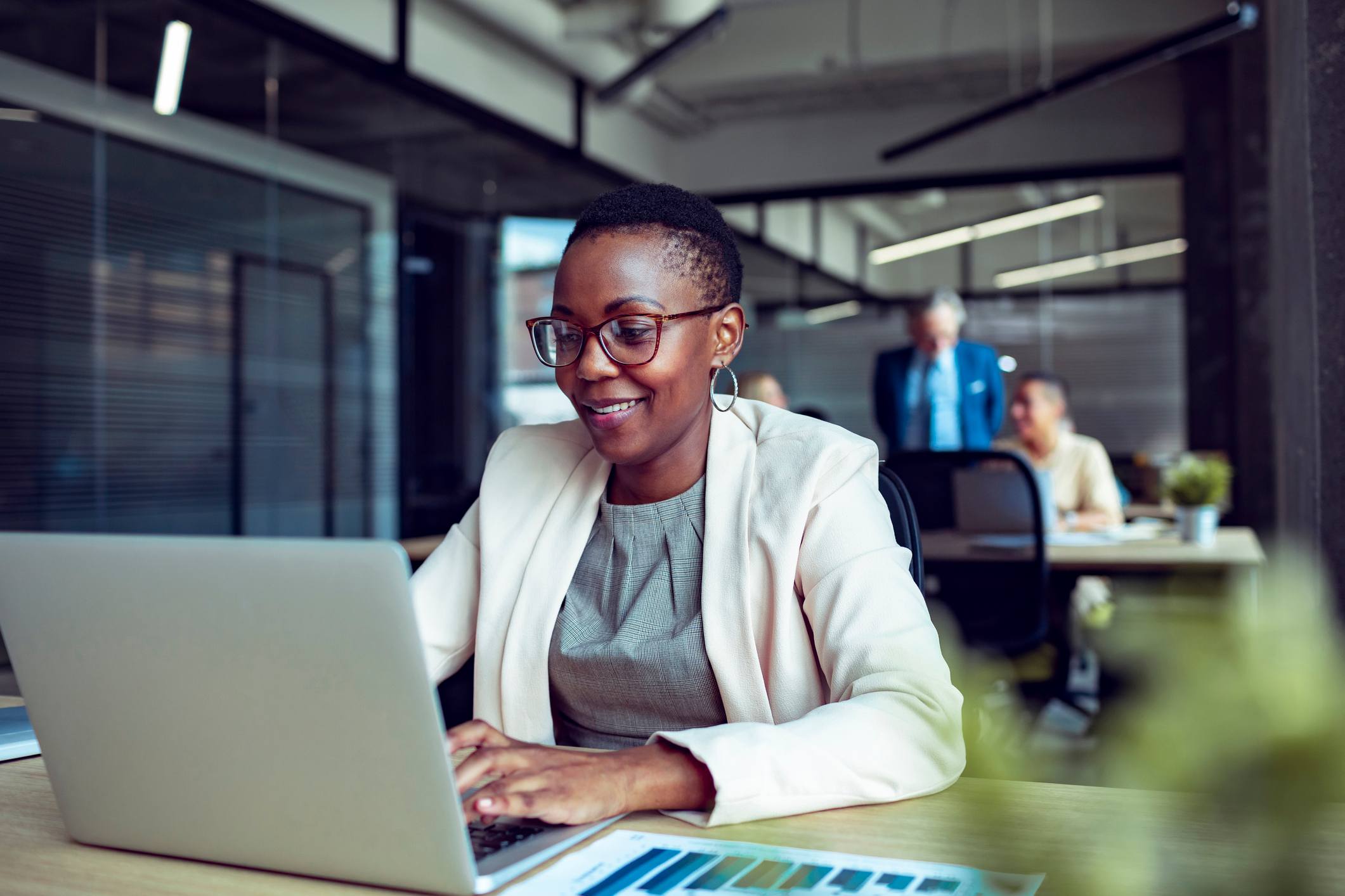 Woman-writing-on-laptop-at-office-promotion-announcement