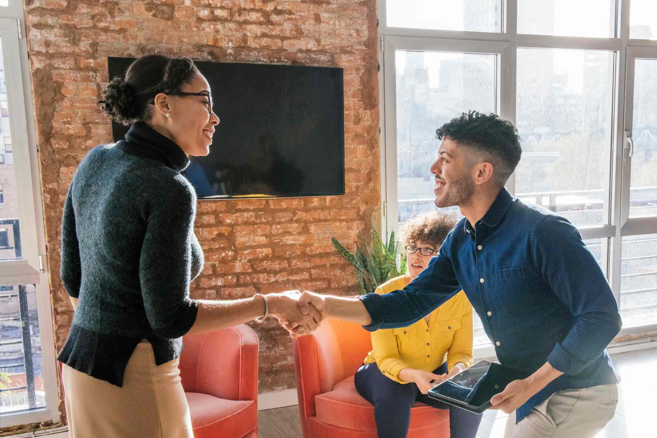 Workers-shaking-hands-at-office-how-to-write-a-professional-email