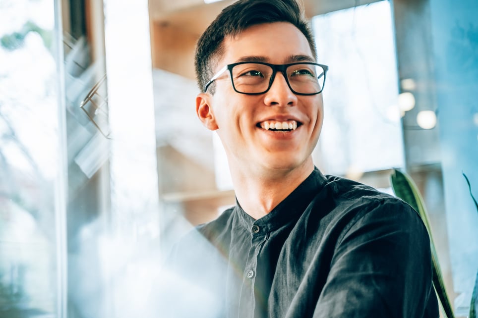 Young-entrepreneur-smiling-and-looking-forward-to-the-future-innovations