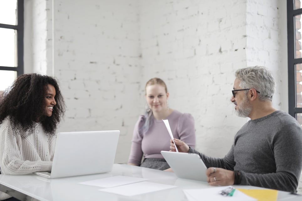 Young-woman-looking-confident-in-job-interview-with-two-recruiters-words-to-describe-yourself