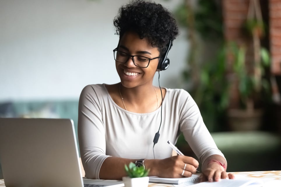 afro-female-worker-smiling-at-work-self-compassion-at-work