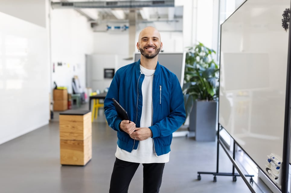 bald-young-man-wearing-blue-jacket-in-an-office-working-as-a-contractor-vs-employee