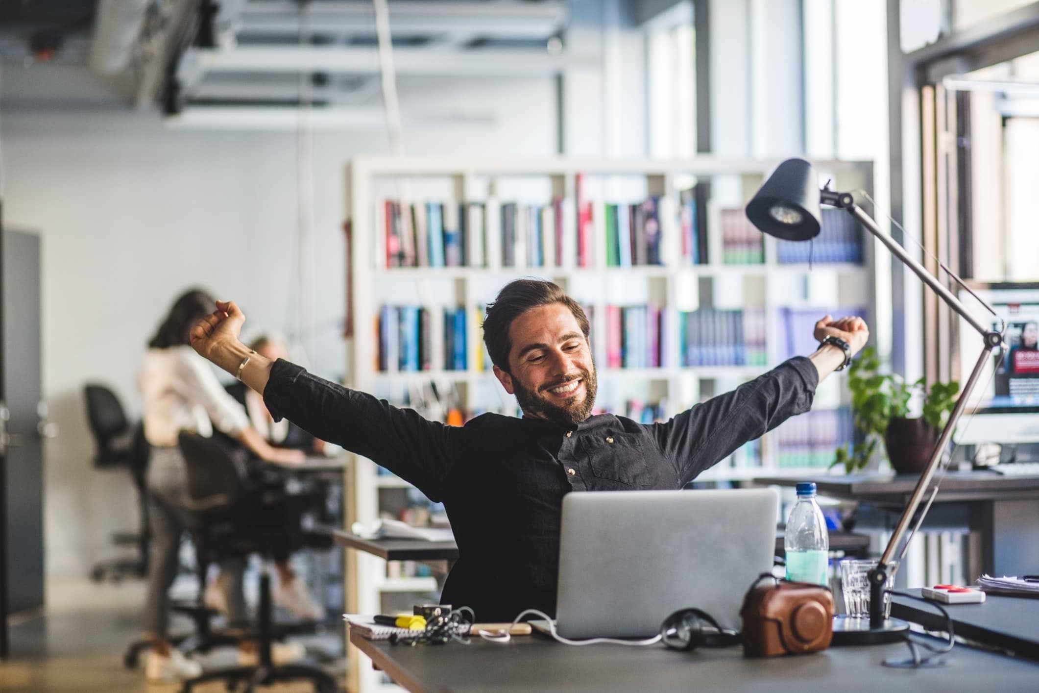 businessman-sitting-with-arms-outstretched-how-to-use-music-to-concentrate