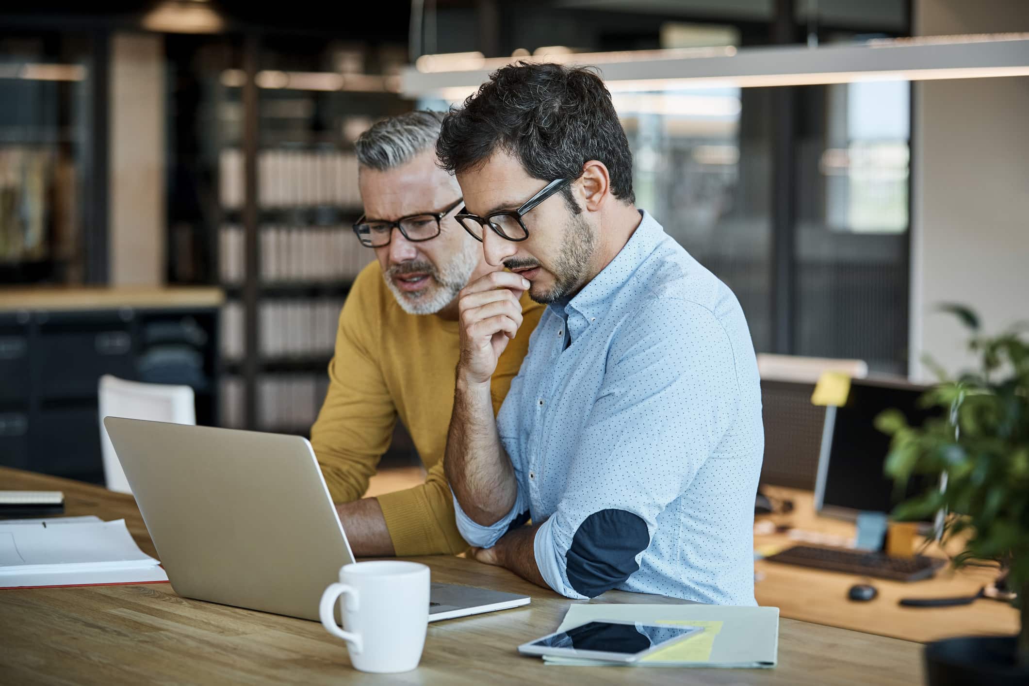 businessmen-using-laptop-at-desk-examples-of-eustress