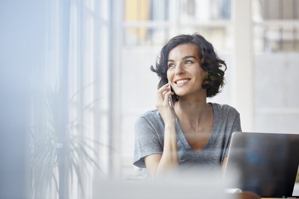 businesswoman-using-mobile-phone-in-office