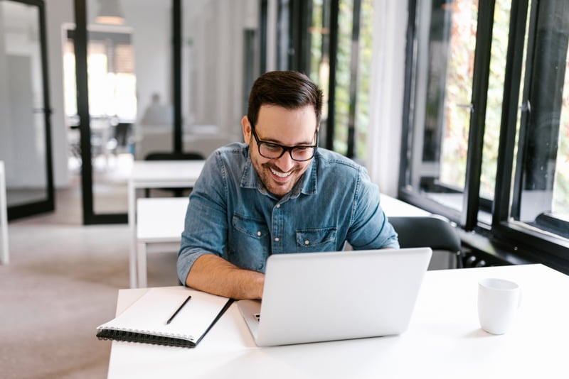 cheerful-businessman-using-laptop-how-to-enjoy-life