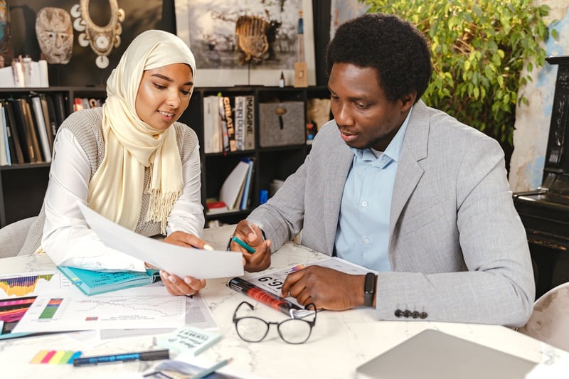 co-workers-viewing-papers-benefits-of-collaboration