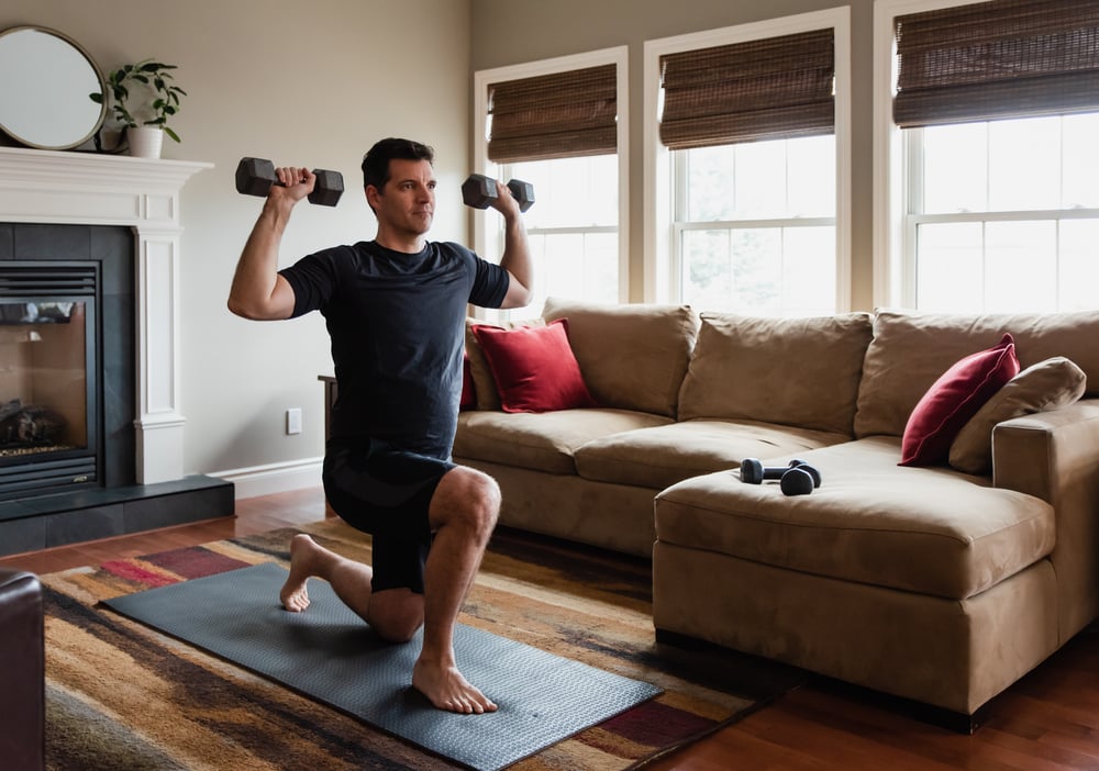 fit-man-exercising-at-home-with-hand-weights-focus-vs-concentration