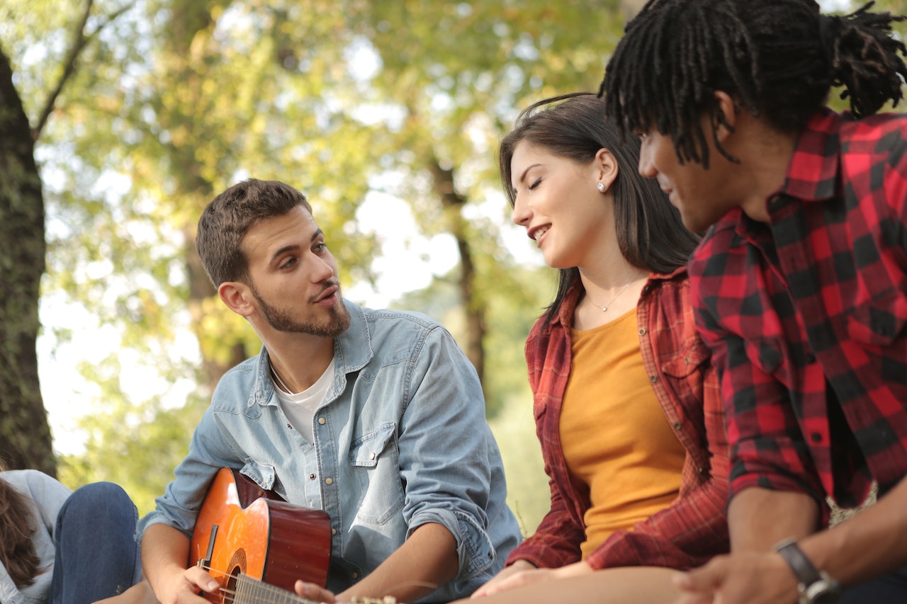 friends-gathered-outdoors-playing-guitar-leaving-a-legacy