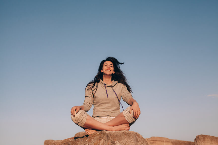 happy-woman-sitting-outside-how-to-recover-from-burnout