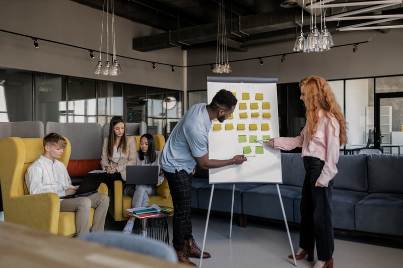 man-and-woman-at-work-writing-on-post-its-tasks-for-a-project-Eisenhower-Matrix