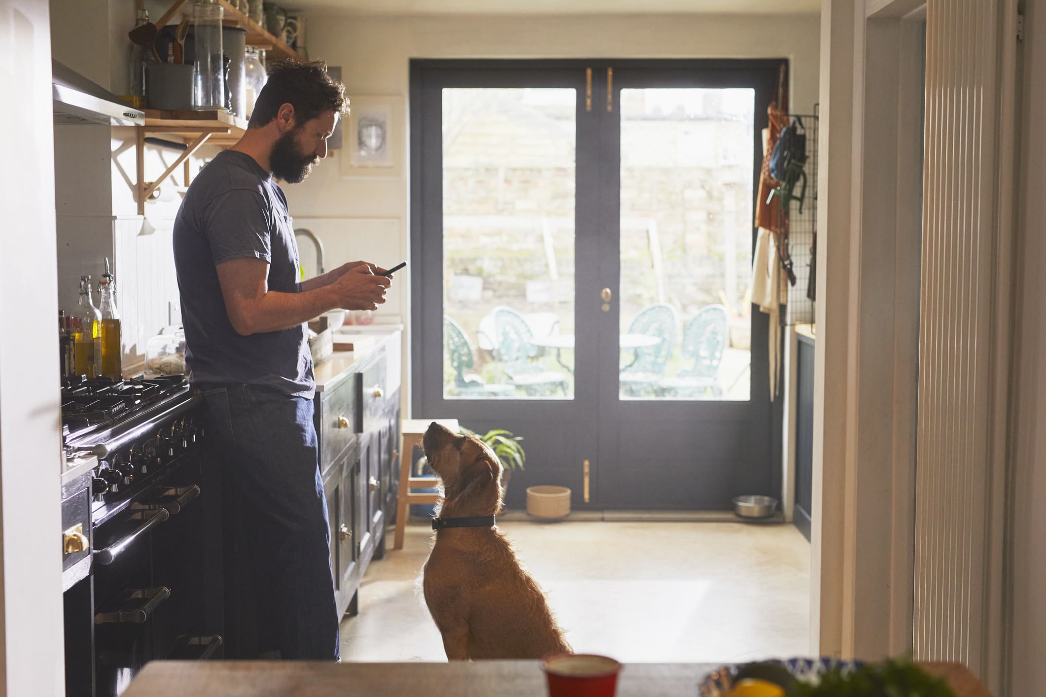 man-in-the-kitchen-using-his-phone-millenials-and-burnout