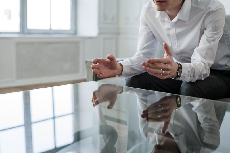 man-sitting-in-chair-explaining-benefits-of-mentorship