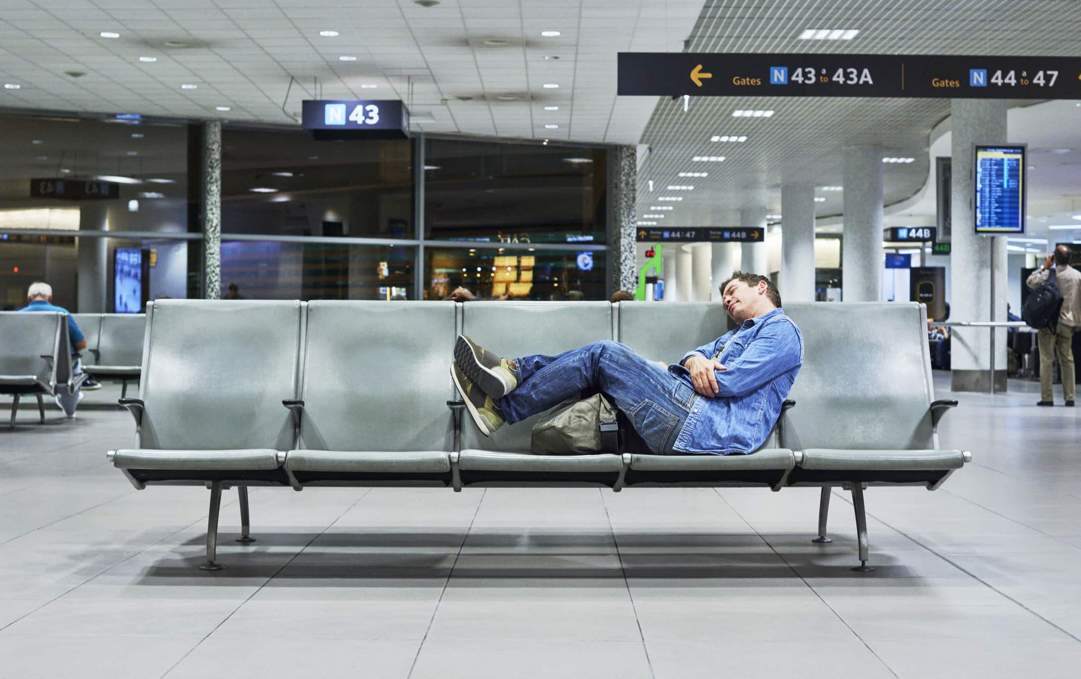 man-sleeping-in-airport-benefits-of-eustress