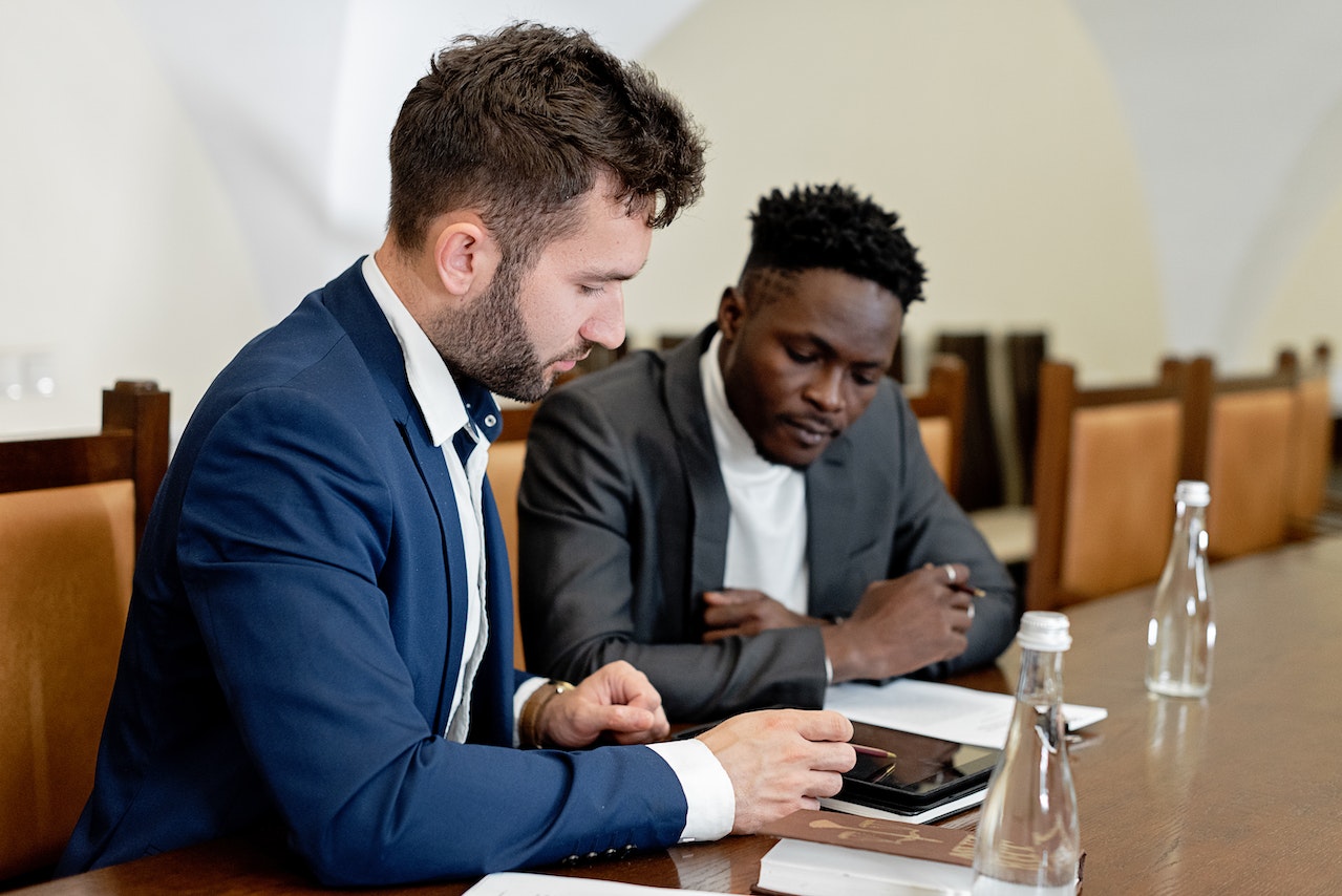 man-with-coworker-looking-together-at-tablet-with-document-leaving-a-legacy