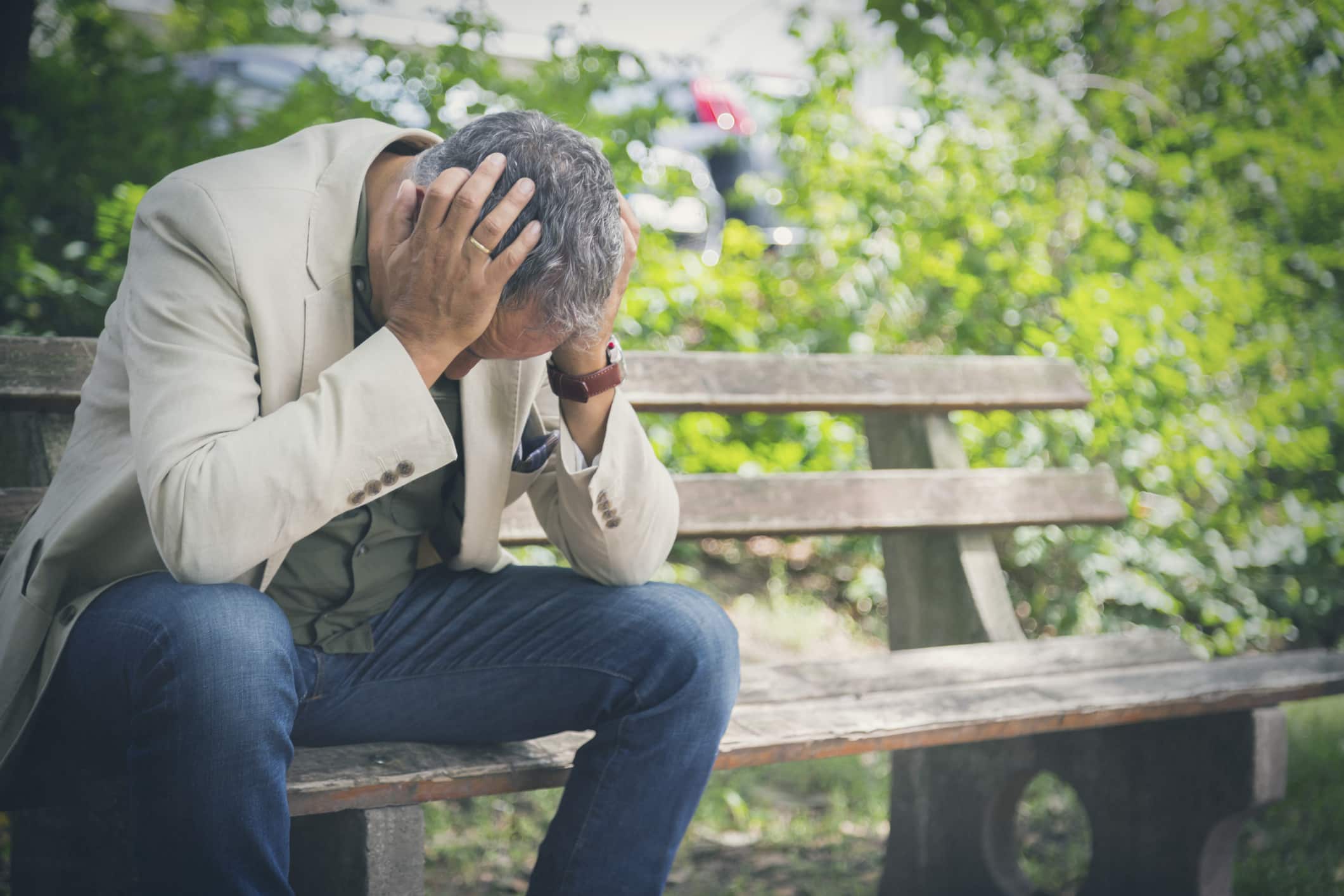 man-with-head-in-his-hands-sitting-on-park-examples-of-eustress