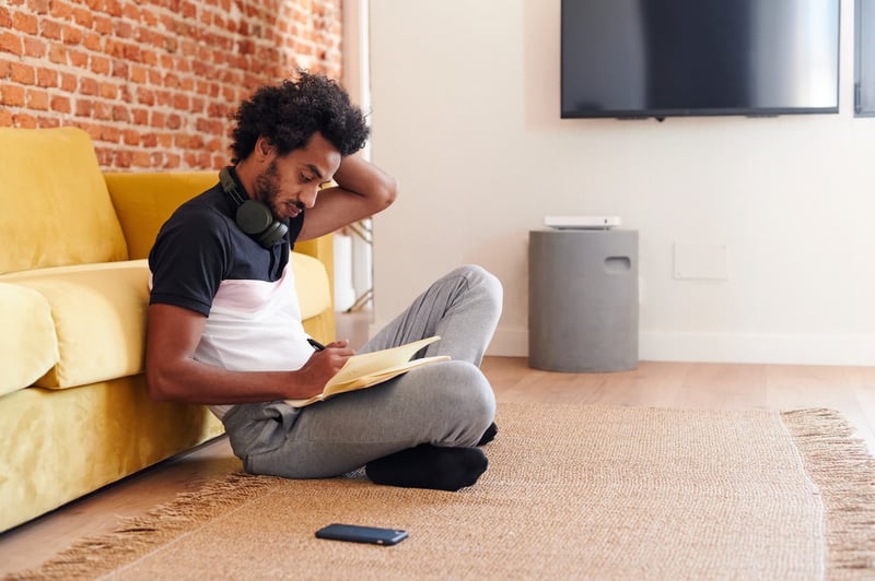 man-writing-in-his-living-room-1