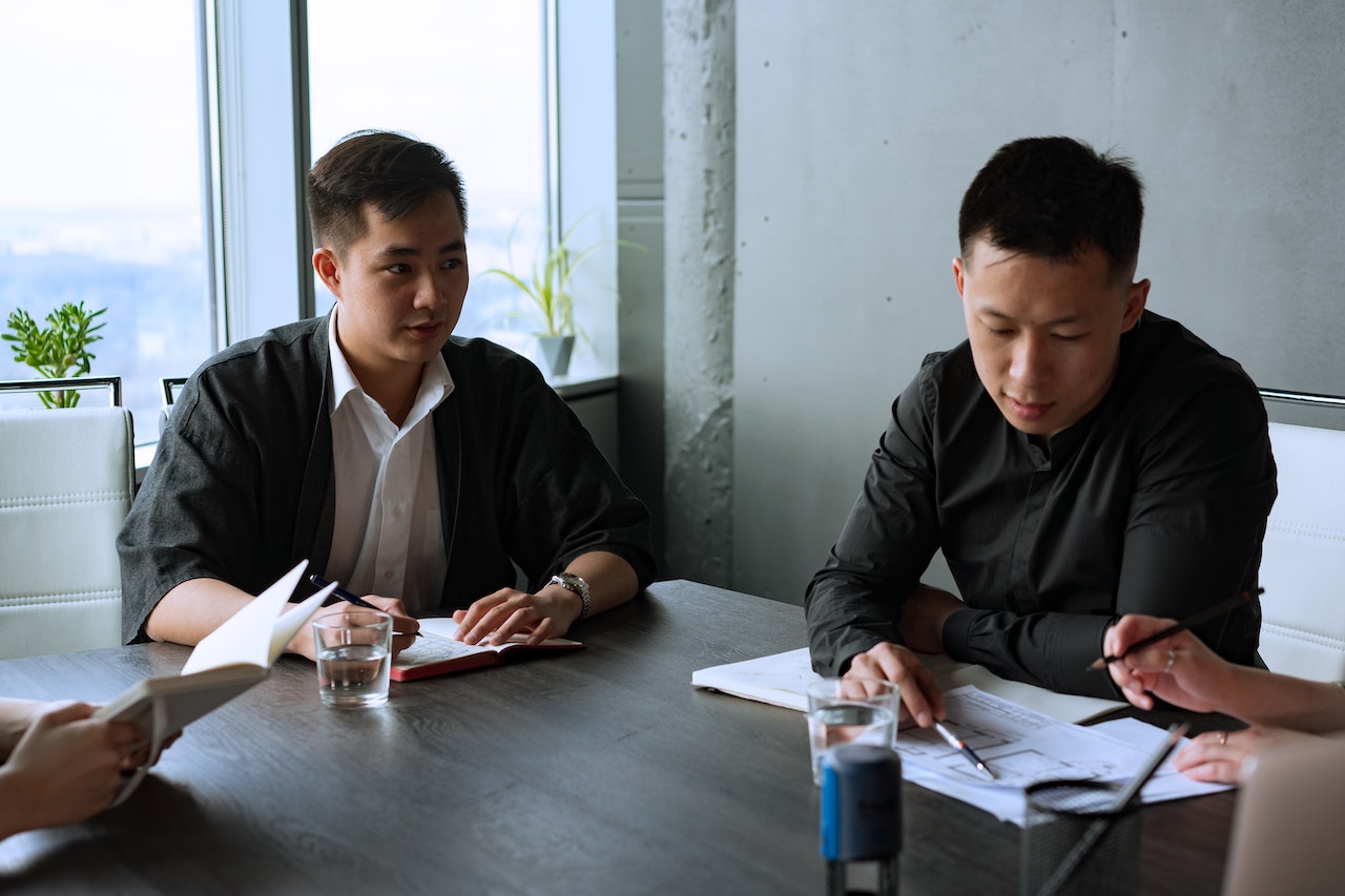 men-sitting-discussing-a-matter-hard-skills-vs-soft-skills