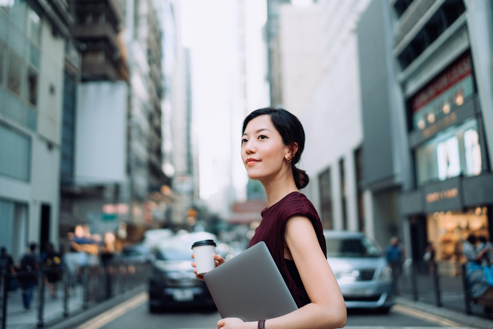 modern-businesswoman-holding-laptop-with-city-traffic-background-how-to-hold-yourself-accountable-1