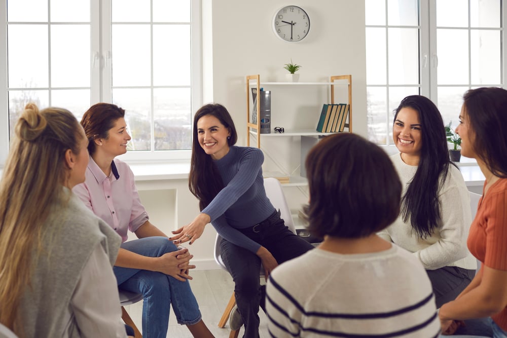 team-members-laughing-while-working-self-awareness-in-leadership