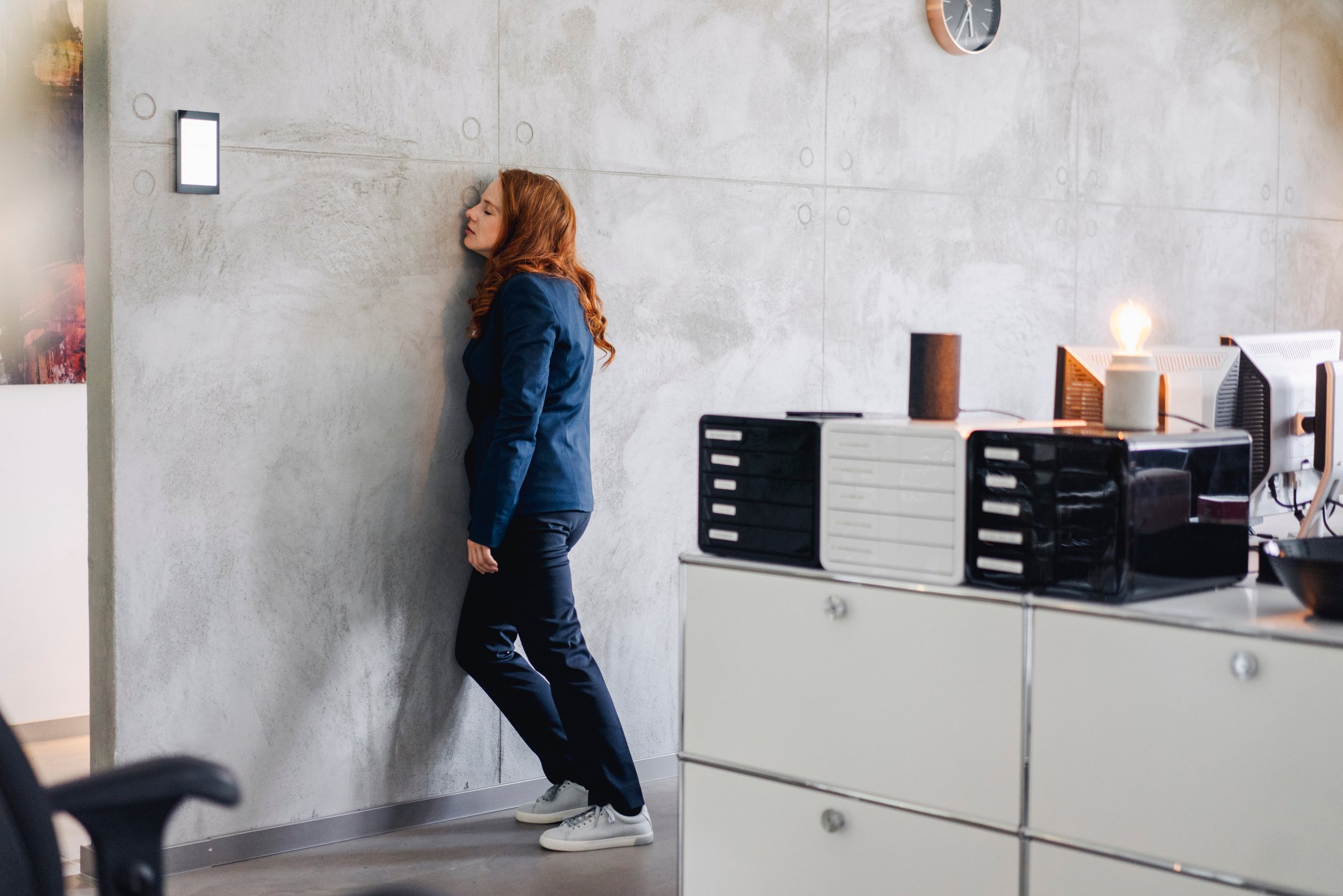 tired-businesswoman-against-a-wall-expressing-emotions