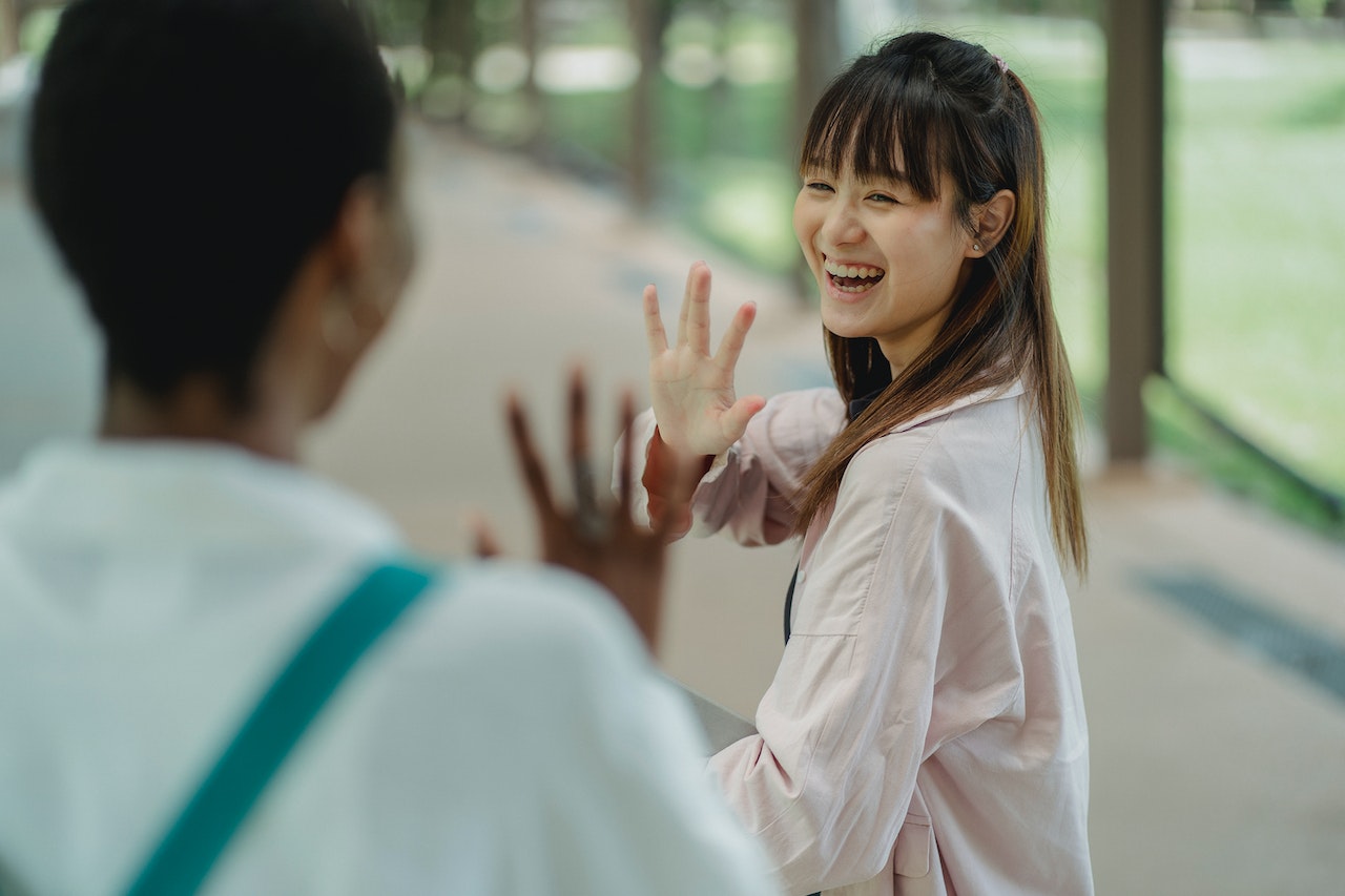 two-women-doing-the-goodbye-gesture