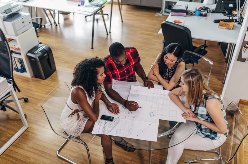 group-discussing-a-project-in-the-office-upskilling