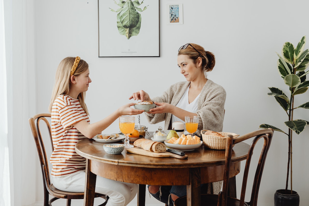 woman-and-her-saughter-eating-lunch-together-at-home-What-Happens-If-You-Sleep-Too-Much