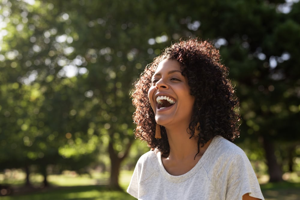 woman-having-fun-at-nature-park-self-compassion-and-motivation