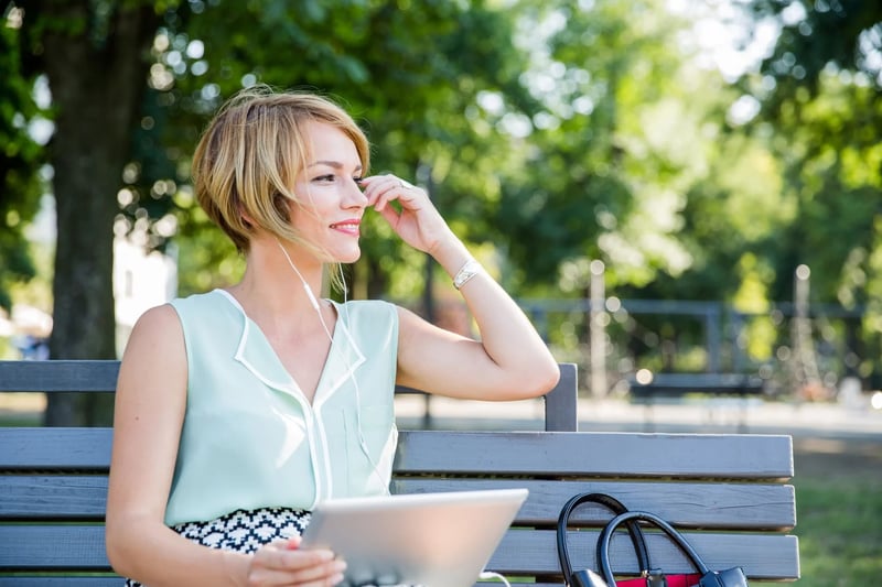 woman-listening-podcast-outdoors