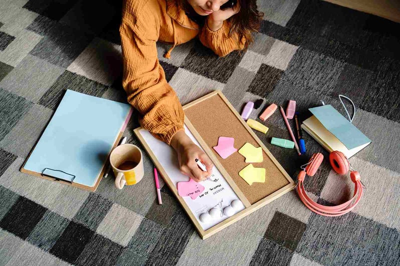 woman-lying-on-the-floor-planning-weekly-schedule-how-to-be-disciplined