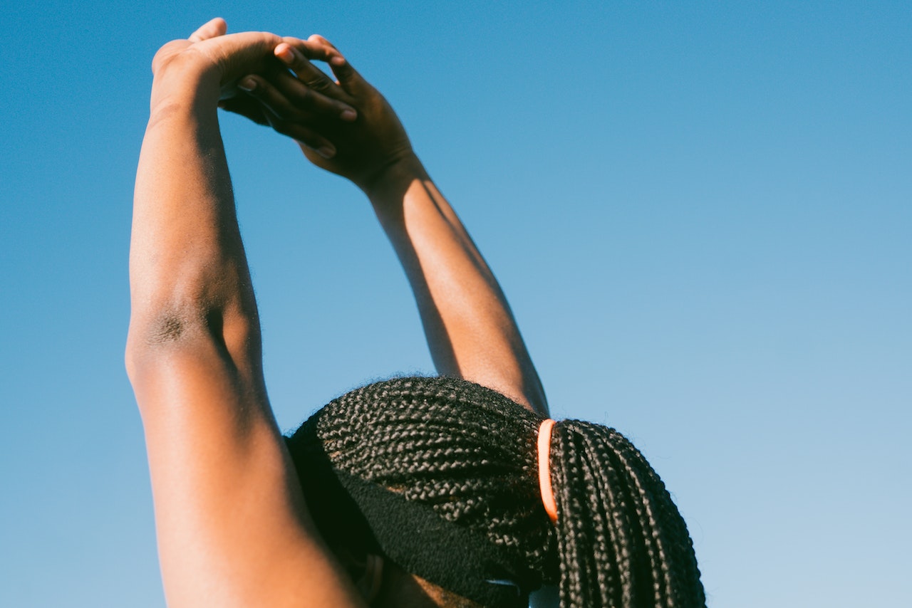 woman-raising-her-arms-stretching-outdoors-leaving-a-legacy
