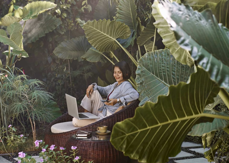 woman-sitting-in-garden-using-laptop-computer-and-mobile-phone-things-to-do-with-your-free-time