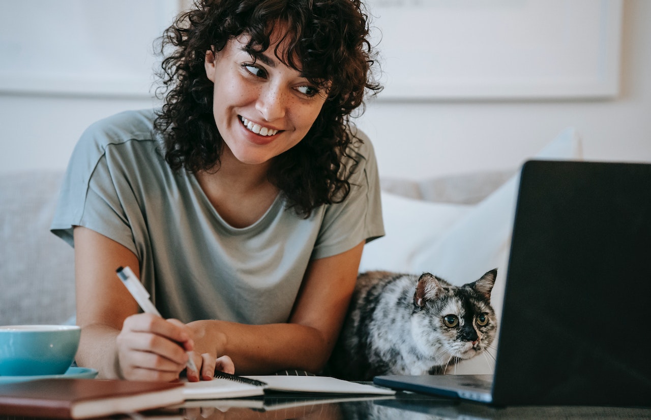 woman-writing-notes-on-notebook-with-laptop-at-home-office-Thank-you-for-your-leadership-and-vision