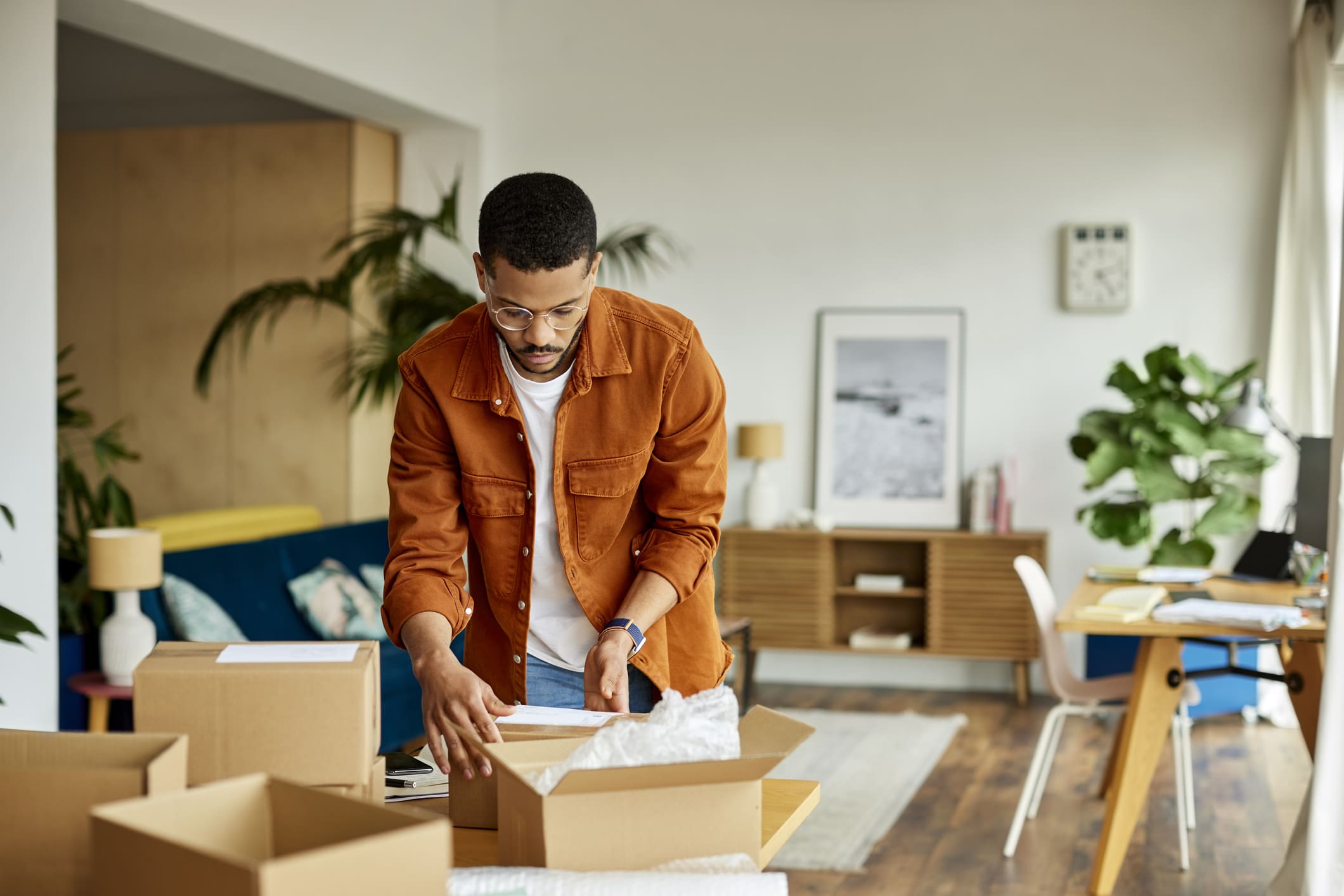 young-businessman-packing-cardboard-box-at-new-house-what-is-a-short-term-goal