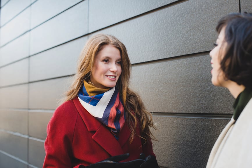 two-women-have-a-conversation-outside-talk-less-listen-more